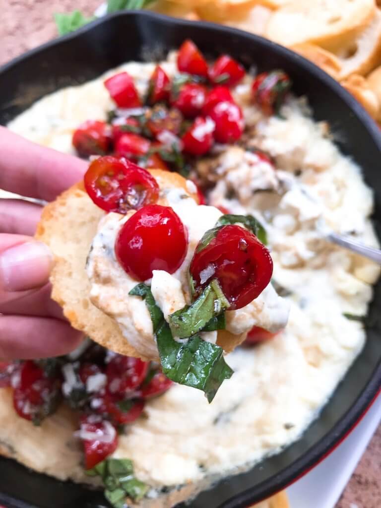 Caprese Cheese Dip is a fast and simple vegetarian Italian appetizer recipe. Three cheeses (mozzarella, cream cheese, Parmesan) are melted with seasonings and topped with fresh tomatoes, fresh basil, and balsamic vinegar. #cheesedip #caprese #italianrecipe