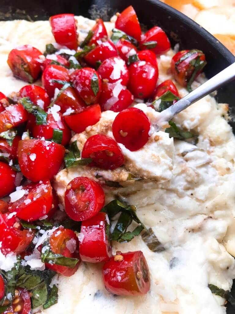 Caprese Cheese Dip is a fast and simple vegetarian Italian appetizer recipe. Three cheeses (mozzarella, cream cheese, Parmesan) are melted with seasonings and topped with fresh tomatoes, fresh basil, and balsamic vinegar. #cheesedip #caprese #italianrecipe