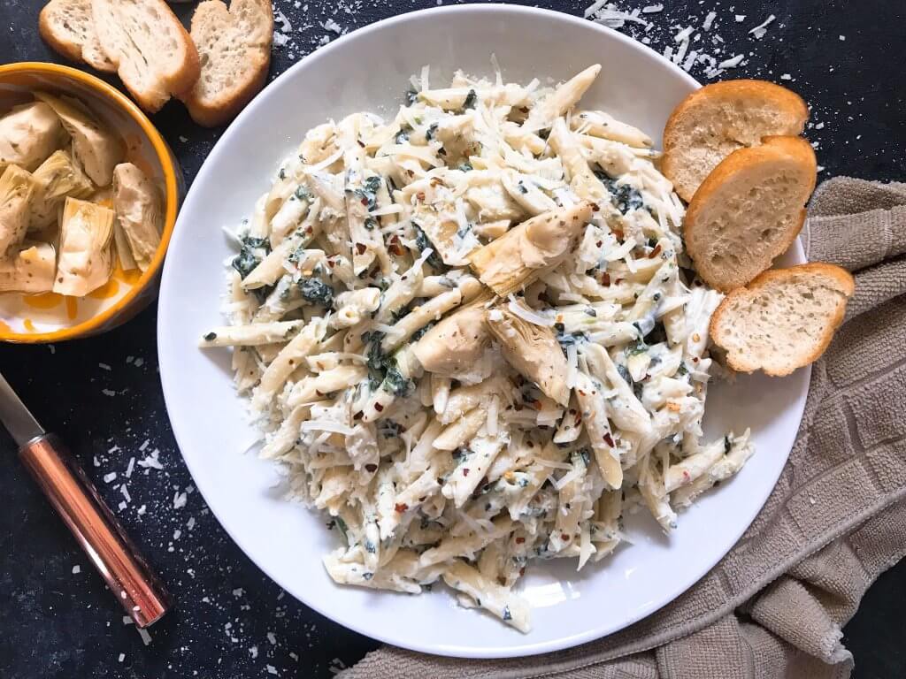 Spinach Artichoke Dip Pasta ready in less than 30 minutes. A cheesy Italian pasta recipe made with three cheeses: Parmesan, cream cheese, and Monterey Jack. Vegetarian. #spinachartichokedip #pastarecipe #italianrecipe