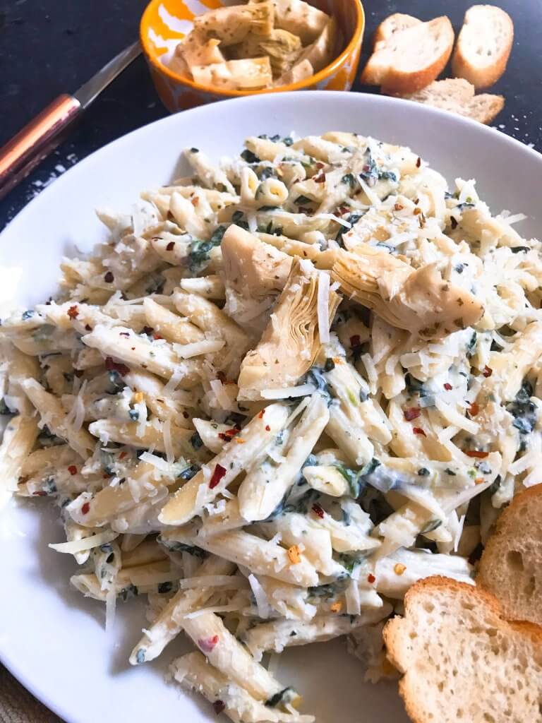 Spinach Artichoke Dip Pasta ready in less than 30 minutes. A cheesy Italian pasta recipe made with three cheeses: Parmesan, cream cheese, and Monterey Jack. Vegetarian. #spinachartichokedip #pastarecipe #italianrecipe