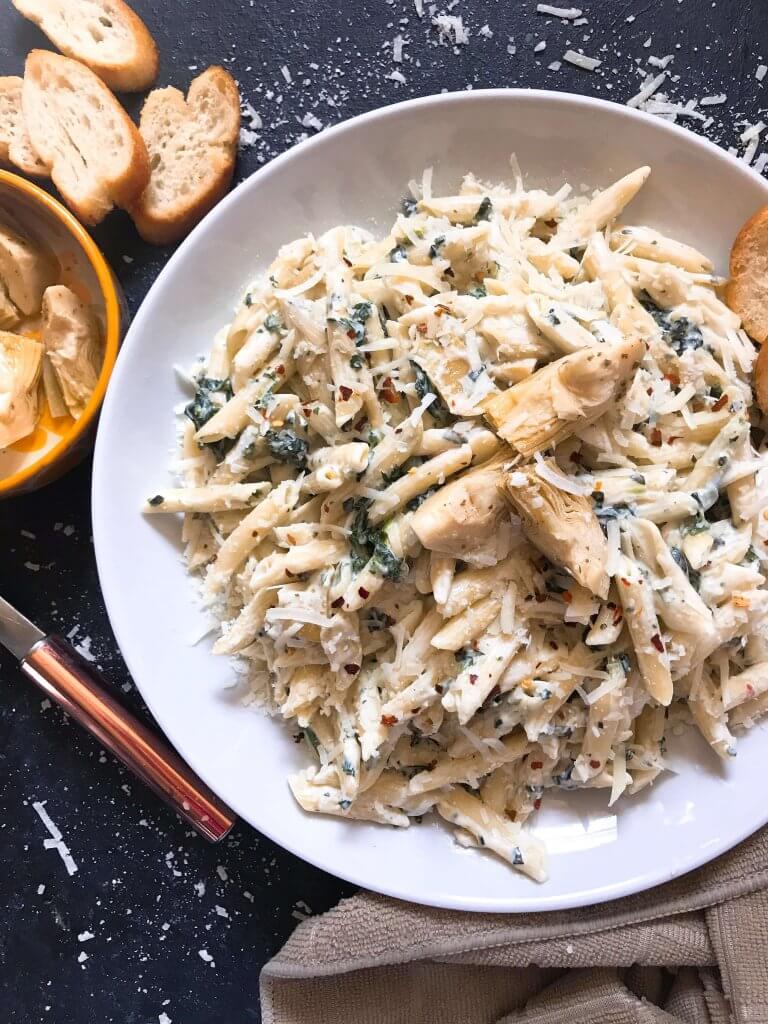 Spinach Artichoke Dip Pasta ready in less than 30 minutes. A cheesy Italian pasta recipe made with three cheeses: Parmesan, cream cheese, and Monterey Jack. Vegetarian. #spinachartichokedip #pastarecipe #italianrecipe