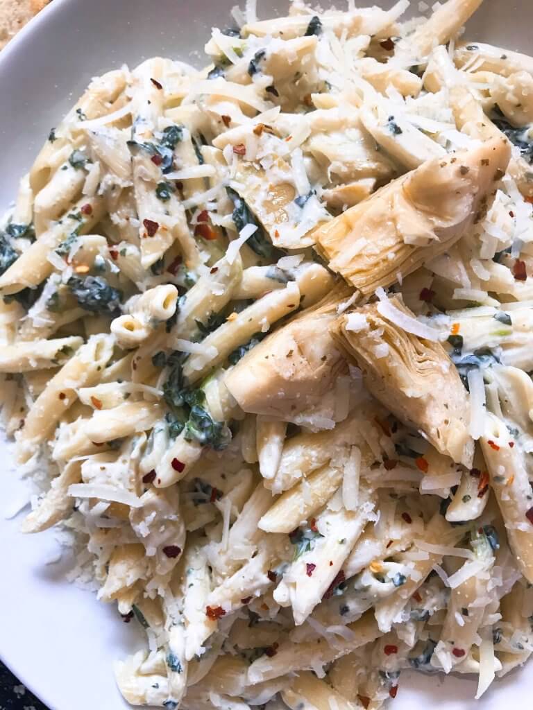 Spinach Artichoke Dip Pasta ready in less than 30 minutes. A cheesy Italian pasta recipe made with three cheeses: Parmesan, cream cheese, and Monterey Jack. Vegetarian. #spinachartichokedip #pastarecipe #italianrecipe