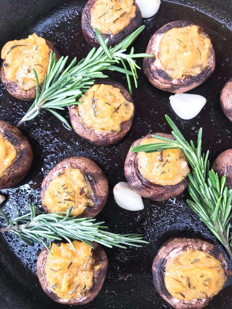 These Garlic Rosemary Polenta Stuffed Mushrooms are a simple and easy appetizer for a party or entertaining. A vegan, vegetarian, gluten free, and dairy free recipe. Leftover cornmeal polenta is a perfect filler. #stuffedmushrooms #partyappetizer #polenta