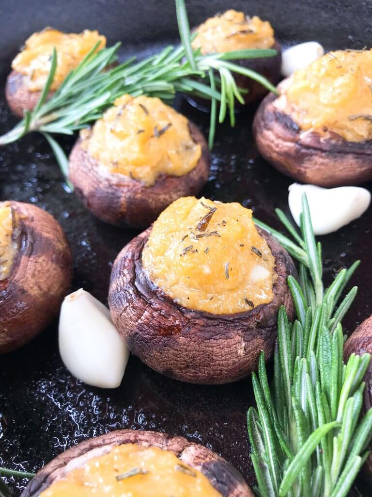 These Garlic Rosemary Polenta Stuffed Mushrooms are a simple and easy appetizer for a party or entertaining. A vegan, vegetarian, gluten free, and dairy free recipe. Leftover cornmeal polenta is a perfect filler. #stuffedmushrooms #partyappetizer #polenta