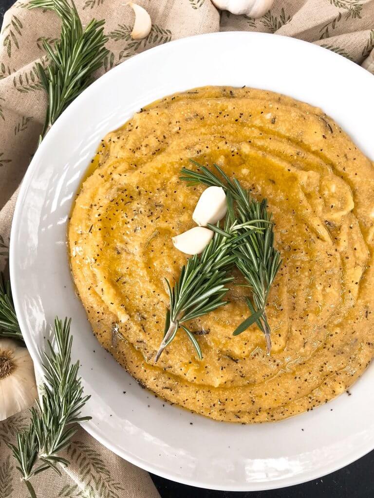 Vegan Garlic Rosemary Polenta is a fast and simple Italian side dish recipe ready in less than 30 minutes made from cornmeal. Vegan, vegetarian, gluten free, dairy free. Quick and easy recipe. #polenta #veganrecipe #veganitalian