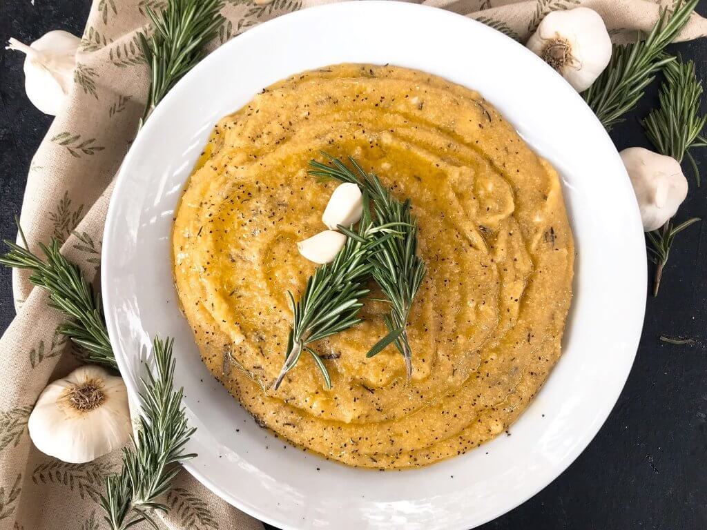 Vegan Garlic Rosemary Polenta is a fast and simple Italian side dish recipe ready in less than 30 minutes made from cornmeal. Vegan, vegetarian, gluten free, dairy free. Quick and easy recipe. #polenta #veganrecipe #veganitalian