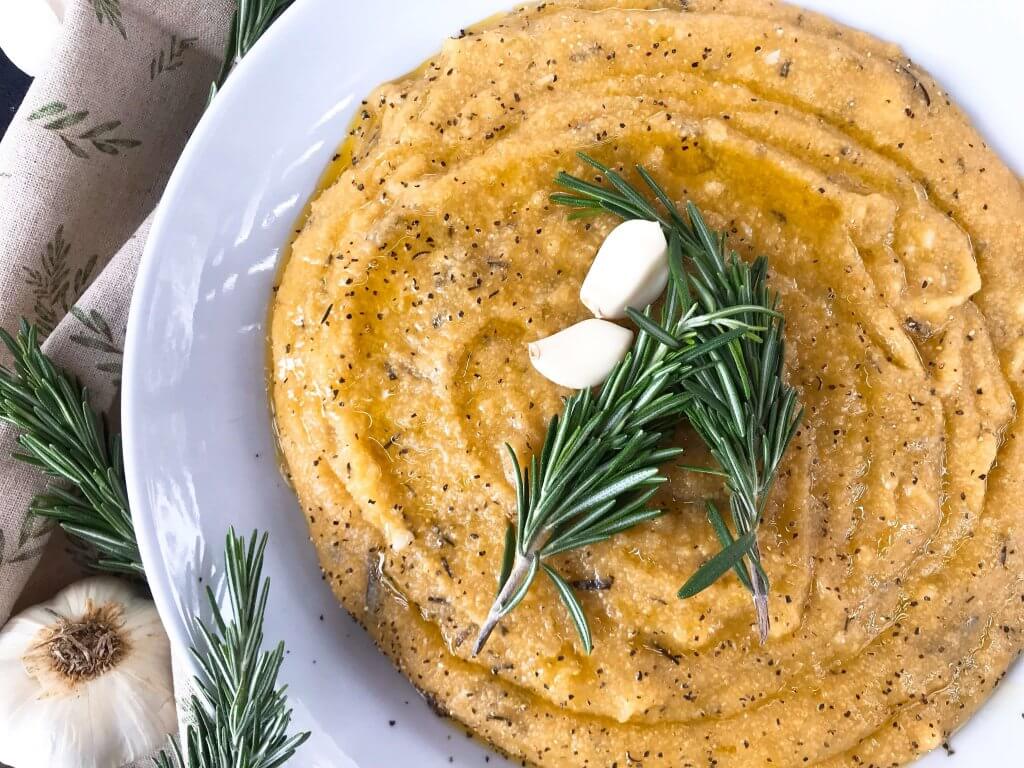 Vegan Garlic Rosemary Polenta is a fast and simple Italian side dish recipe ready in less than 30 minutes made from cornmeal. Vegan, vegetarian, gluten free, dairy free. Quick and easy recipe. #polenta #veganrecipe #veganitalian