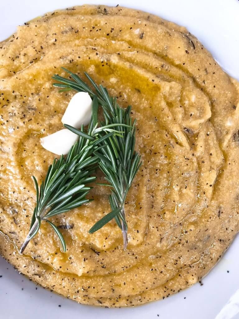 Vegan Garlic Rosemary Polenta is a fast and simple Italian side dish recipe ready in less than 30 minutes made from cornmeal. Vegan, vegetarian, gluten free, dairy free. Quick and easy recipe. #polenta #veganrecipe #veganitalian