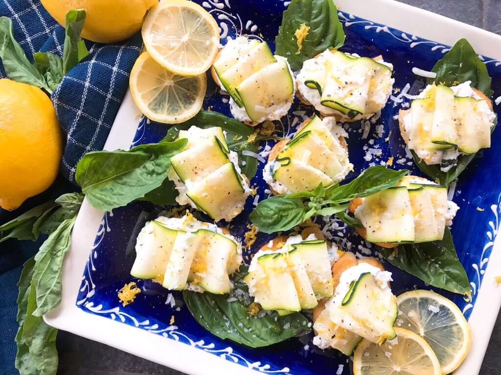 Horizontal blue and white plate with Zucchini Lemon Ricotta Crostini