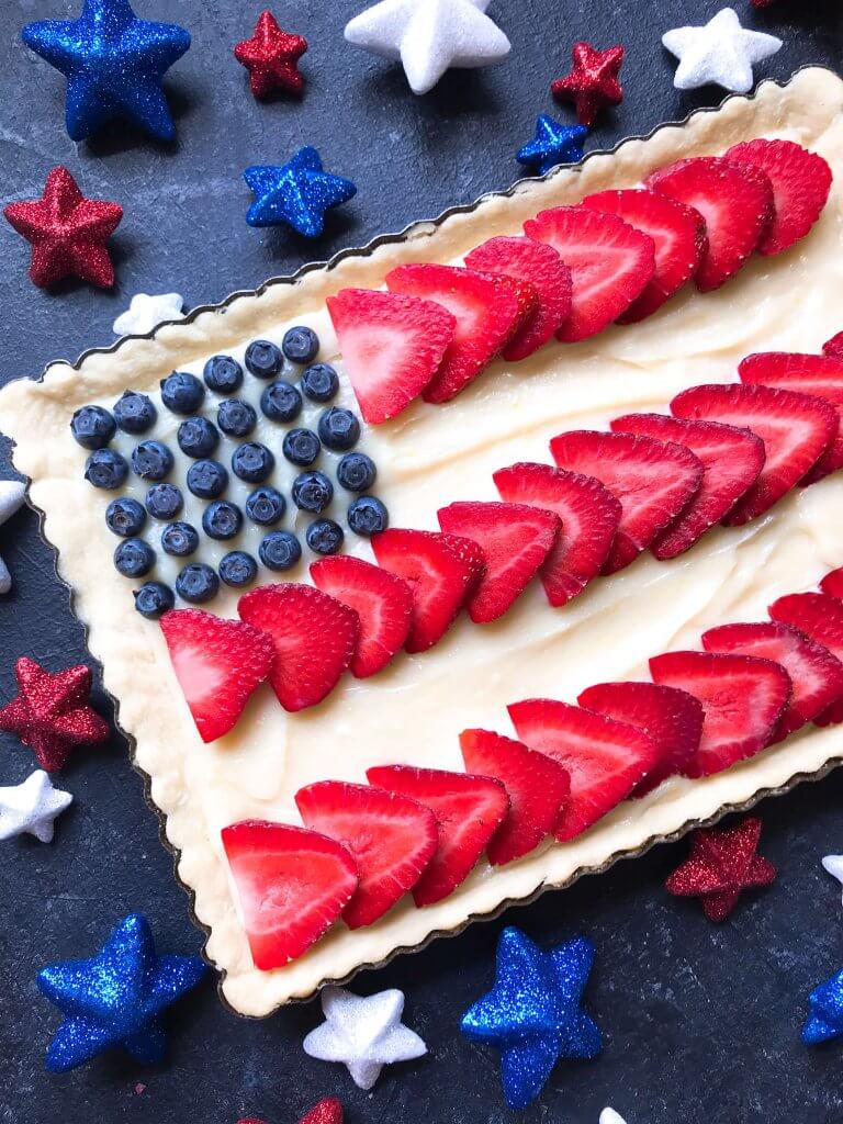 A quick and simple red, white, and blue dessert ready in 30 minutes. Patriotic American Flag Fruit Tart is a lemon cream cheese tart with fresh strawberries and blueberries. Great recipe for Labor Day, Memorial Day, and 4th of July BBQ or cookout. #americanrecipes #redwhitebluerecipes #redwhitebluedessert #fruittart