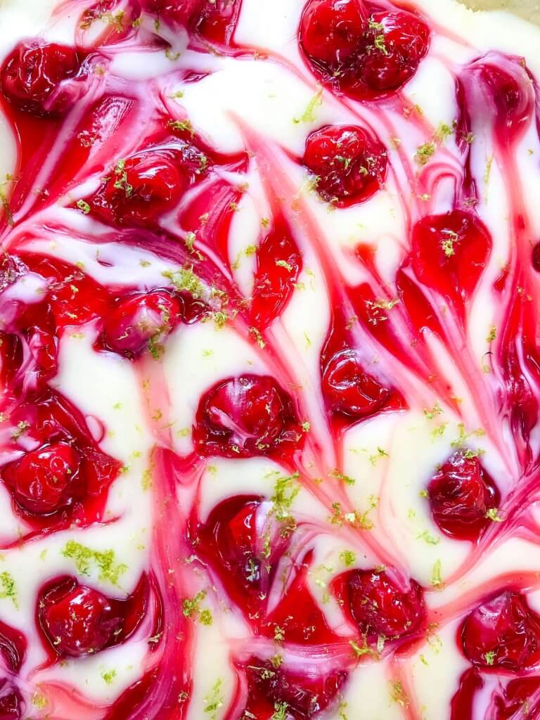 This fast and easy Cherry Limeade Tart is a perfect summer dessert recipe. A soft lime crust is filled with lime cream cheese filling and cherry pie swirls. #cherrylimeade #summerdessert #cherrydessert #tart