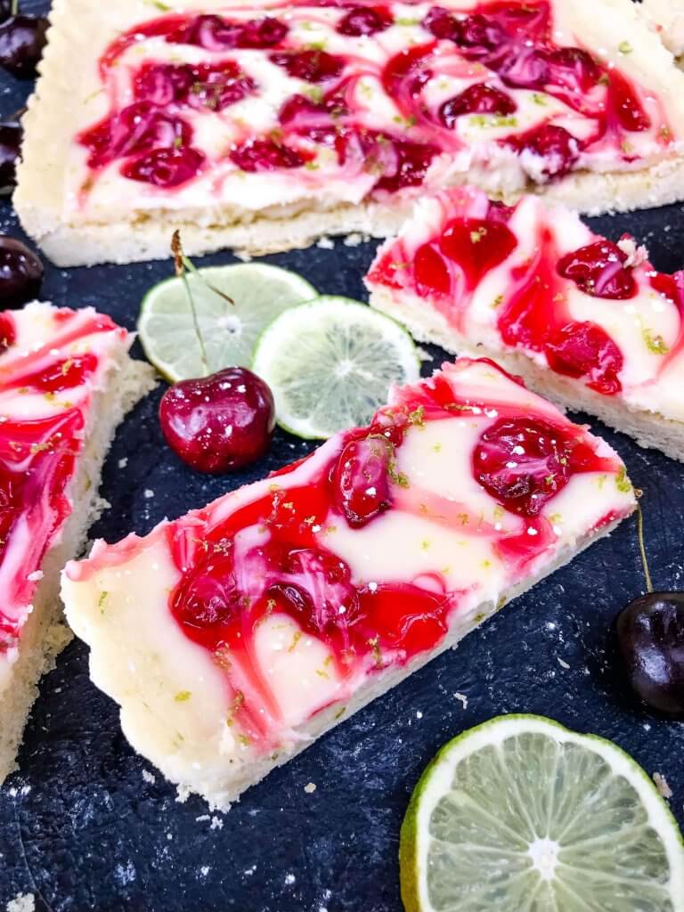 This fast and easy Cherry Limeade Tart is a perfect summer dessert recipe. A soft lime crust is filled with lime cream cheese filling and cherry pie swirls. #cherrylimeade #summerdessert #cherrydessert #tart