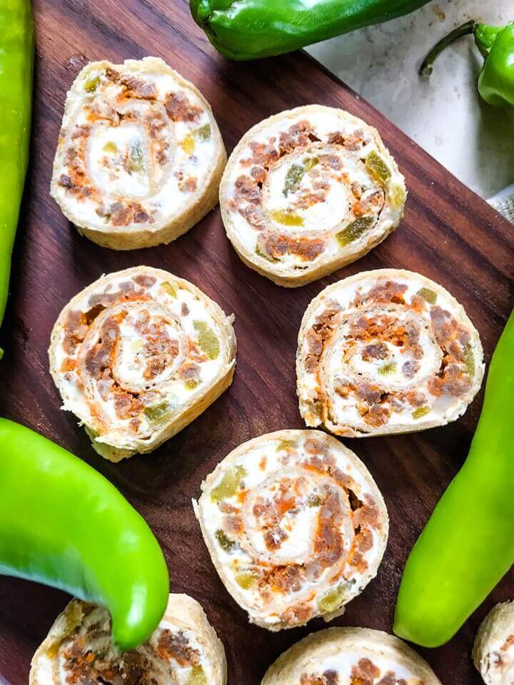 A fast and easy appetizer recipe great for game day, party food, and entertaining. Hatch Green Chile Chorizo Pinwheels are filled with a cream cheese mixture, chorizo sausage, and chile peppers. #hatchchiles #greenchile #gamedayrecipes