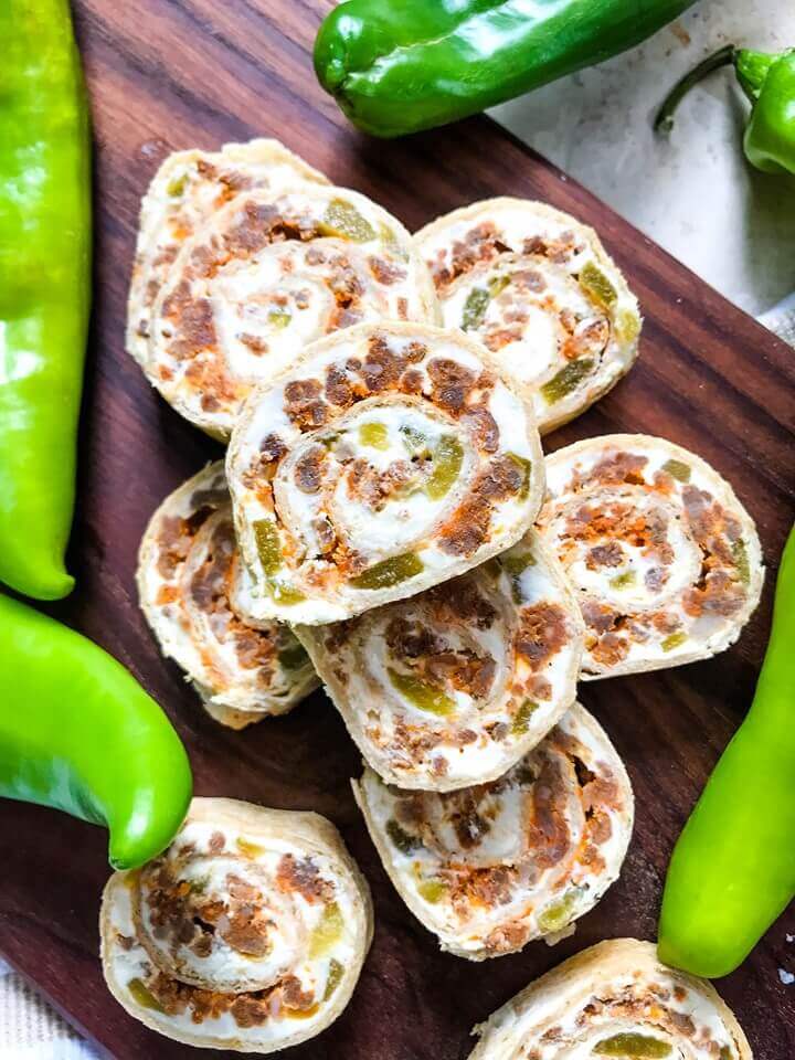 A fast and easy appetizer recipe great for game day, party food, and entertaining. Hatch Green Chile Chorizo Pinwheels are filled with a cream cheese mixture, chorizo sausage, and chile peppers. #hatchchiles #greenchile #gamedayrecipes