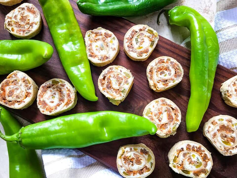 A fast and easy appetizer recipe great for game day, party food, and entertaining. Hatch Green Chile Chorizo Pinwheels are filled with a cream cheese mixture, chorizo sausage, and chile peppers. #hatchchiles #greenchile #gamedayrecipes