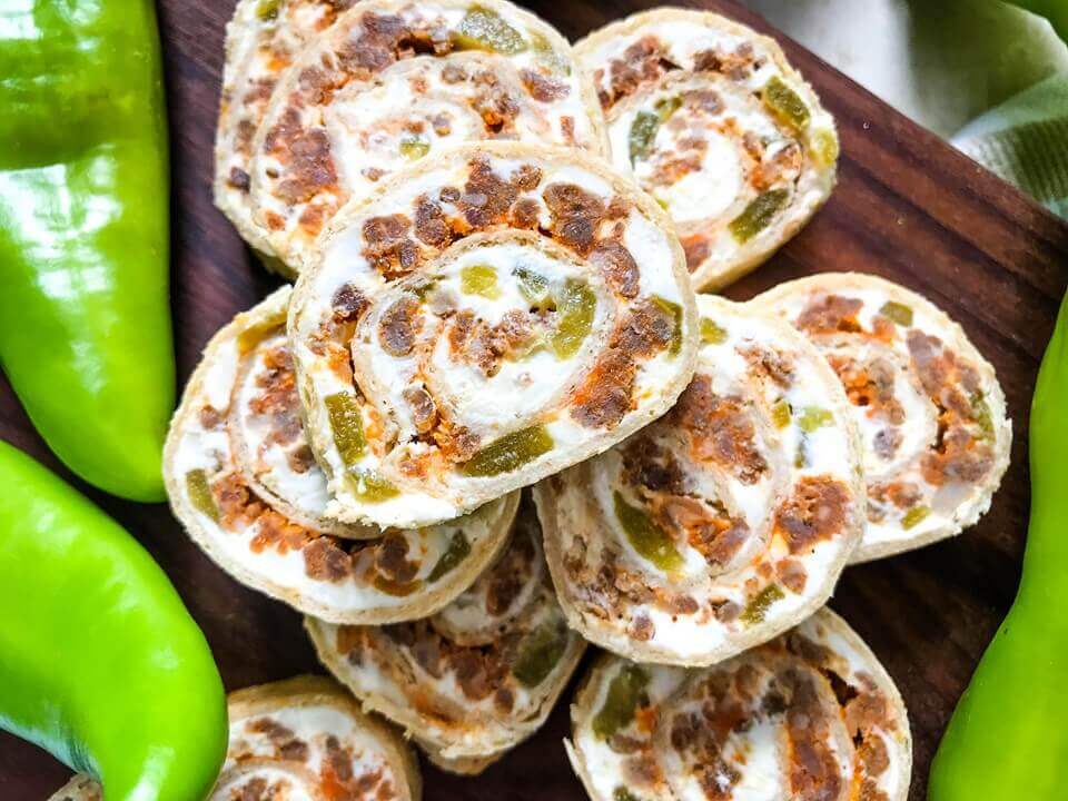 A fast and easy appetizer recipe great for game day, party food, and entertaining. Hatch Green Chile Chorizo Pinwheels are filled with a cream cheese mixture, chorizo sausage, and chile peppers. #hatchchiles #greenchile #gamedayrecipes