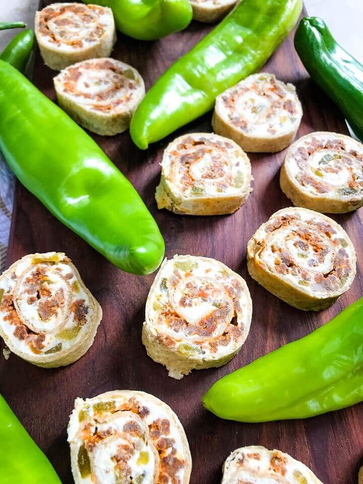 A fast and easy appetizer recipe great for game day, party food, and entertaining. Hatch Green Chile Chorizo Pinwheels are filled with a cream cheese mixture, chorizo sausage, and chile peppers. #hatchchiles #greenchile #gamedayrecipes