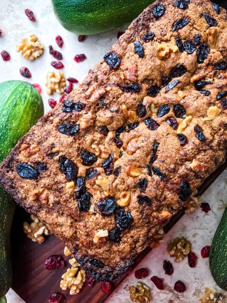 Cranberry Walnut Zucchini Bread is a simple bread filled with shredded courgette zucchini squash, dried cranberries, and chopped walnuts. A warm, spiced bread, this recipe is great as a snack or toasted with some butter. Vegetarian bread recipe.