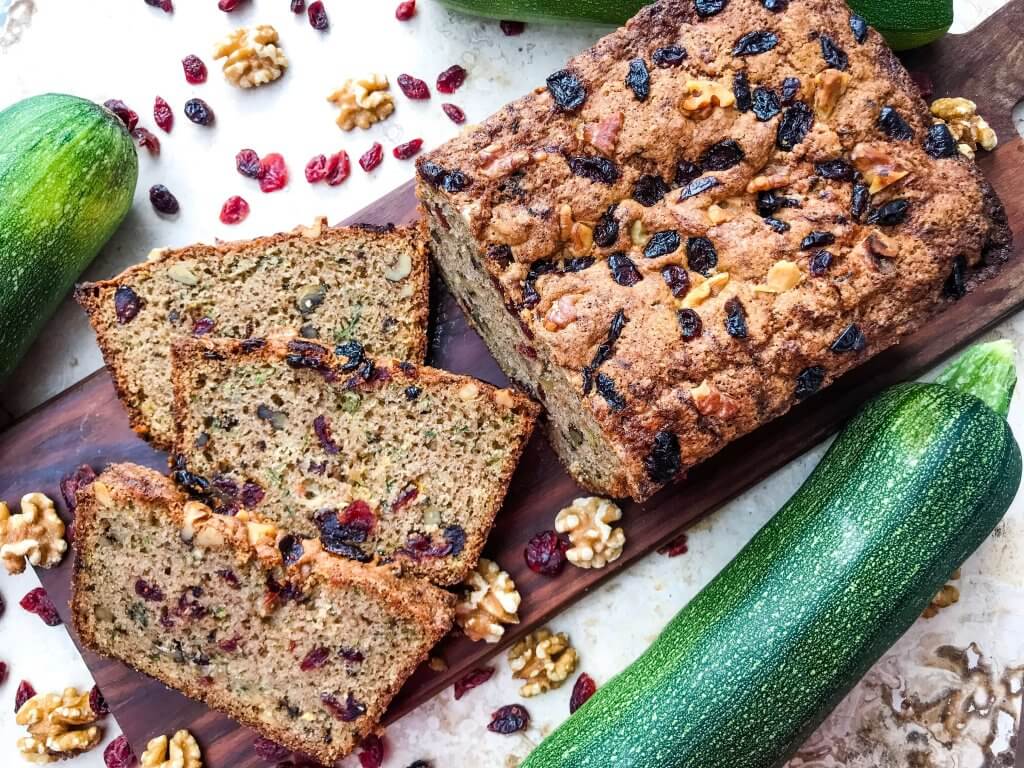 Cranberry Walnut Zucchini Bread is a simple bread filled with shredded courgette zucchini squash, dried cranberries, and chopped walnuts. A warm, spiced bread, this recipe is great as a snack or toasted with some butter. Vegetarian bread recipe.