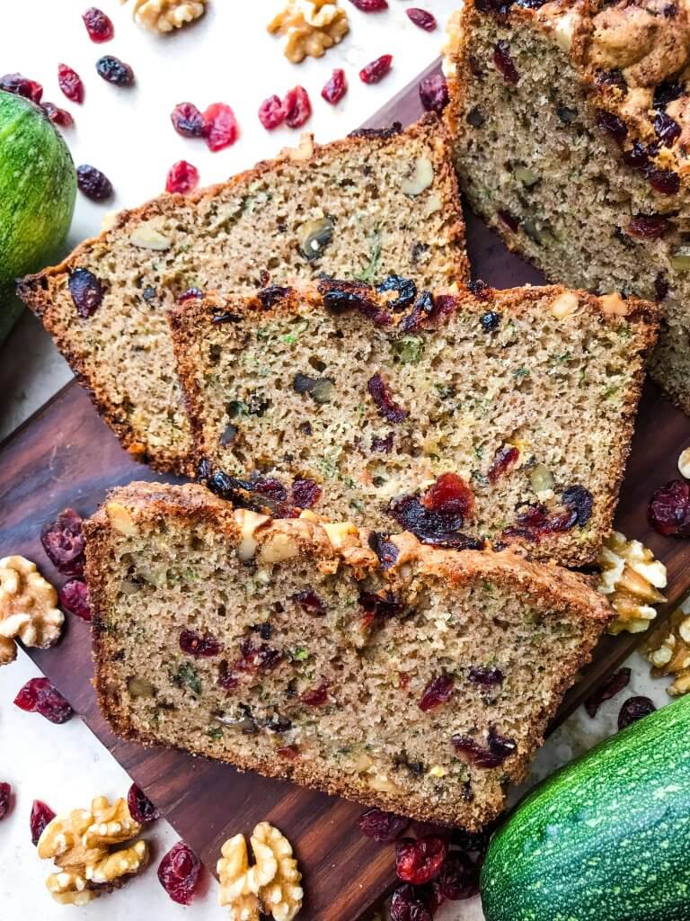 Cranberry Walnut Zucchini Bread is a simple bread filled with shredded courgette zucchini squash, dried cranberries, and chopped walnuts. A warm, spiced bread, this recipe is great as a snack or toasted with some butter. Vegetarian bread recipe.