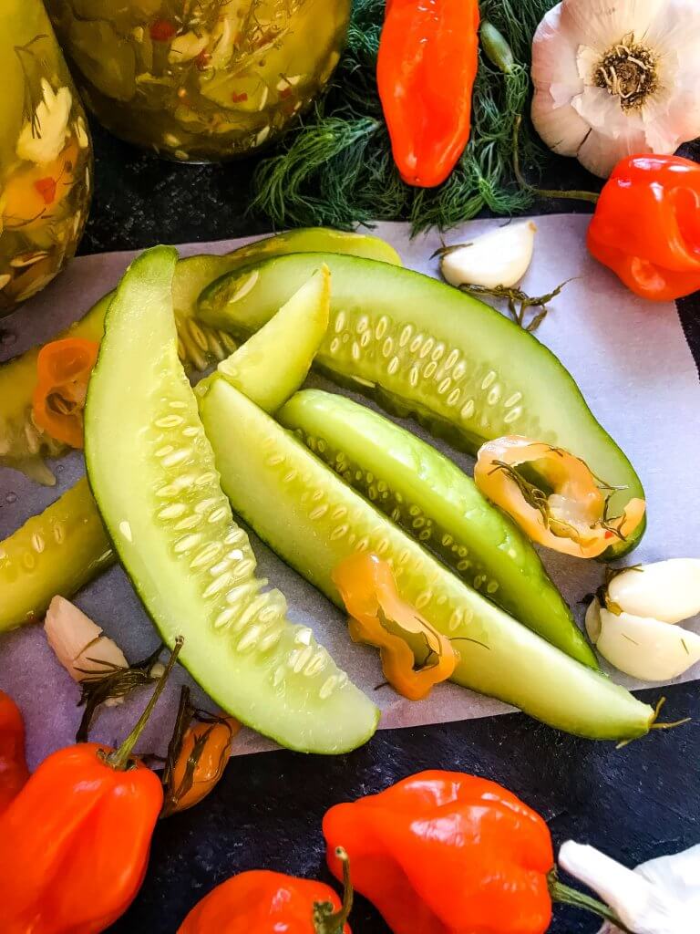 These homemade spicy pickles are easy to make! A dill pickle with a hint of garlic and a spicy pepper kick, these Homemade Habanero Garlic Pickles are vegan, vegetarian, gluten free, and dairy free. Cut the cucumbers in any shape you prefer. #homemadepickles #spicypickles