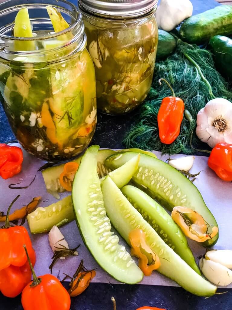 These homemade spicy pickles are easy to make! A dill pickle with a hint of garlic and a spicy pepper kick, these Homemade Habanero Garlic Pickles are vegan, vegetarian, gluten free, and dairy free. Cut the cucumbers in any shape you prefer. #homemadepickles #spicypickles