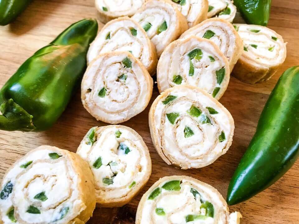 Just 20 minutes to make these Jalapeno Popper Pinwheels, a great game day or party appetizer recipe. Cream cheese mixture is blended with more cheese, spices, and diced jalapeno peppers for a twist on a classic. Vegetarian. #gamedayrecipe #rollups #pinwheels #appetizerrecipes