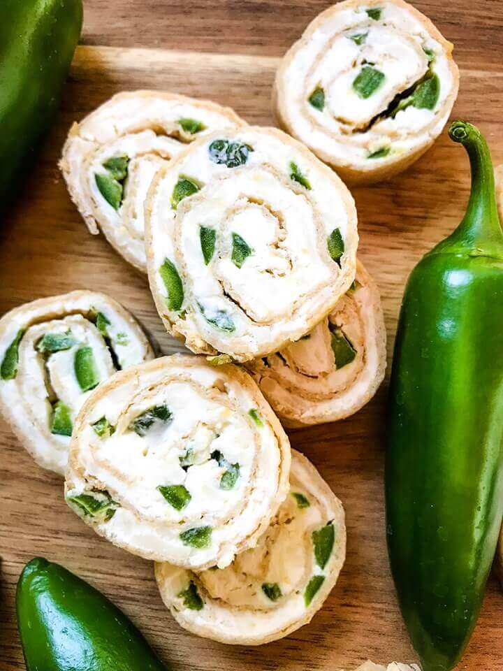 Just 20 minutes to make these Jalapeno Popper Pinwheels, a great game day or party appetizer recipe. Cream cheese mixture is blended with more cheese, spices, and diced jalapeno peppers for a twist on a classic. Vegetarian. #gamedayrecipe #rollups #pinwheels #appetizerrecipes