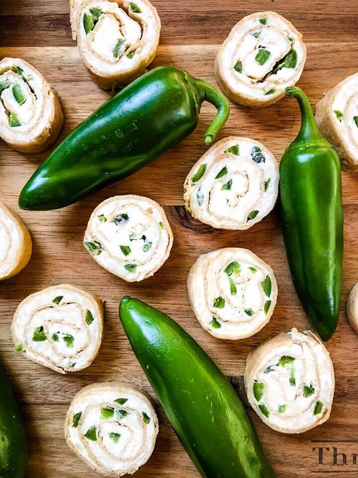 Just 20 minutes to make these Jalapeno Popper Pinwheels, a great game day or party appetizer recipe. Cream cheese mixture is blended with more cheese, spices, and diced jalapeno peppers for a twist on a classic. Vegetarian. #gamedayrecipe #rollups #pinwheels #appetizerrecipes