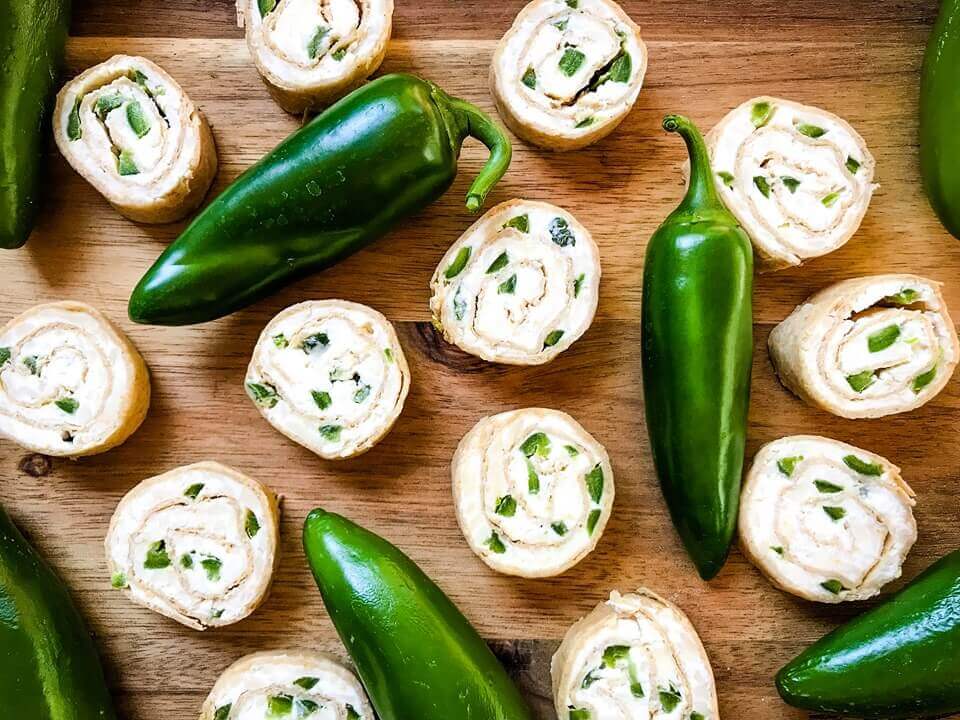 Just 20 minutes to make these Jalapeno Popper Pinwheels, a great game day or party appetizer recipe. Cream cheese mixture is blended with more cheese, spices, and diced jalapeno peppers for a twist on a classic. Vegetarian. #gamedayrecipe #rollups #pinwheels #appetizerrecipes