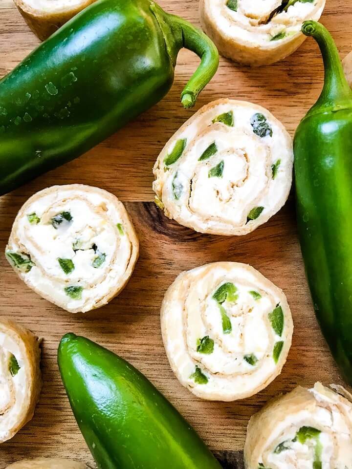 Just 20 minutes to make these Jalapeno Popper Pinwheels, a great game day or party appetizer recipe. Cream cheese mixture is blended with more cheese, spices, and diced jalapeno peppers for a twist on a classic. Vegetarian. #gamedayrecipe #rollups #pinwheels #appetizerrecipes