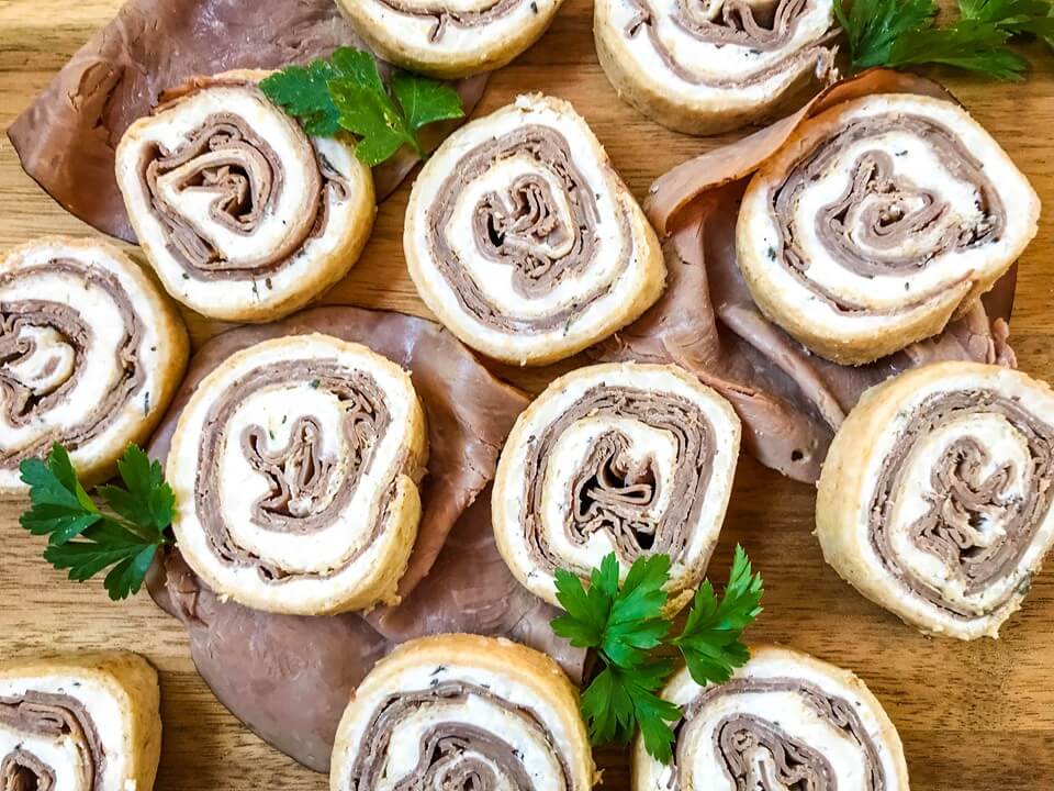 A fast and easy appetizer recipe ready in 20 minutes, Horseradish Roast Beef Pinwheels combine classic flavors in a party finger food. Roast beef is layered with a horseradish cream cheese mixture and rolled in flour tortillas. #gamedayrecipes #partyappetizers #holidayappetizers