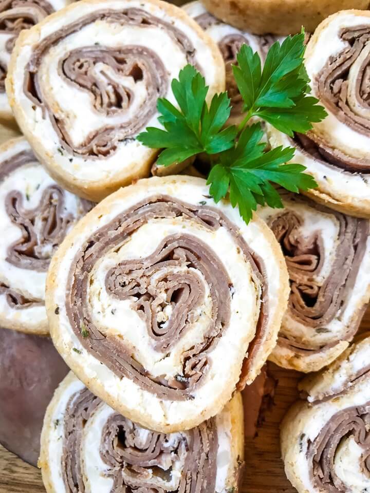 A fast and easy appetizer recipe ready in 20 minutes, Horseradish Roast Beef Pinwheels combine classic flavors in a party finger food. Roast beef is layered with a horseradish cream cheese mixture and rolled in flour tortillas. #gamedayrecipes #partyappetizers #holidayappetizers