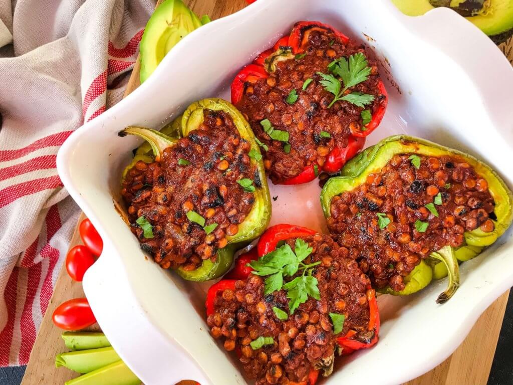 Vegan Lentil Taco Stuffed Peppers are bell peppers stuffed with lentils cooked in a taco tomato sauce. Vegan stuffed peppers are gluten free and vegetarian Mexican food recipe. #veganstuffedpeppers #stuffedpeppers #vegantacos