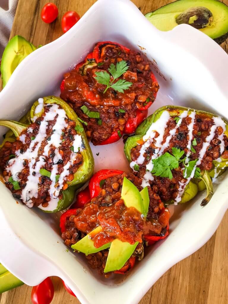 Vegan Lentil Taco Stuffed Peppers are bell peppers stuffed with lentils cooked in a taco tomato sauce. Vegan stuffed peppers are gluten free and vegetarian Mexican food recipe. #veganstuffedpeppers #stuffedpeppers #vegantacos