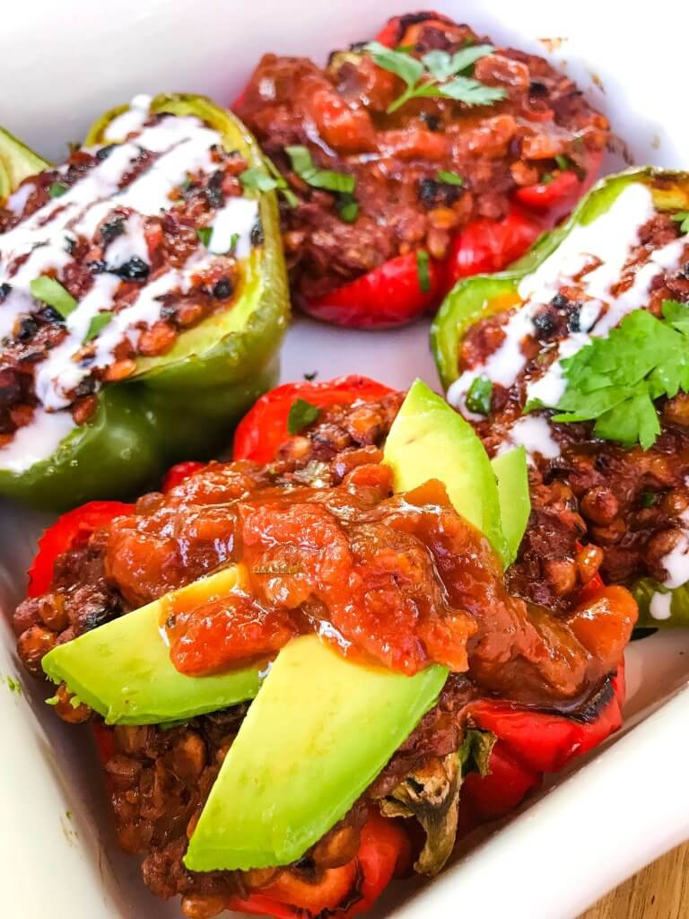 Vegan Lentil Taco Stuffed Peppers are bell peppers stuffed with lentils cooked in a taco tomato sauce. Vegan stuffed peppers are gluten free and vegetarian Mexican food recipe. #veganstuffedpeppers #stuffedpeppers #vegantacos