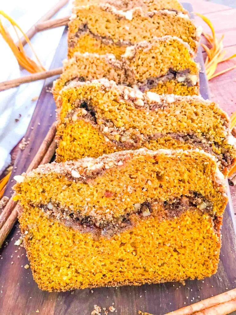 Slices of Cinnamon Streusel Pumpkin Bread on a board in a row