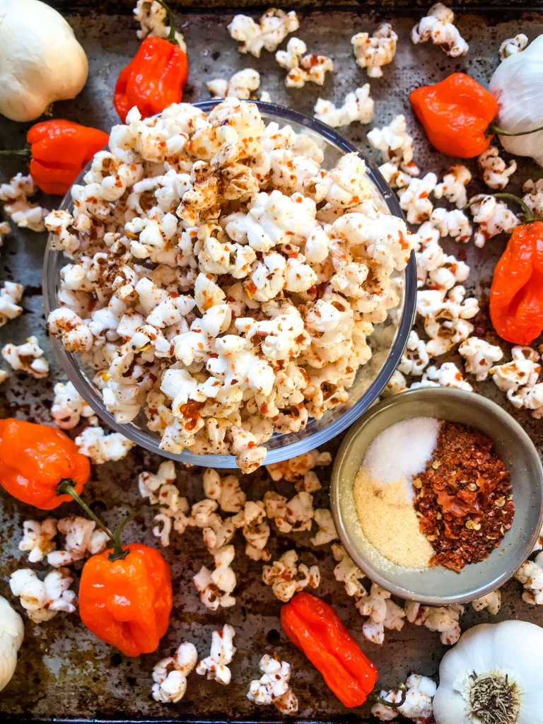 This Homemade Habanero Garlic Spicy Popcorn is a spicy snack recipe great for entertaining, party food, and game day. Vegan, vegetarian, gluten free. use any ground pepper with garlic powder and salt for a seasoning kick. #homemadepopcorn #spicyrecipe #spicyfood