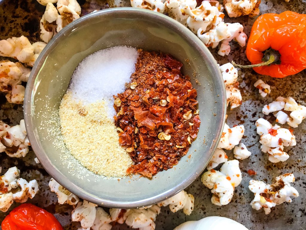 This Homemade Habanero Garlic Spicy Popcorn is a spicy snack recipe great for entertaining, party food, and game day. Vegan, vegetarian, gluten free. use any ground pepper with garlic powder and salt for a seasoning kick. #homemadepopcorn #spicyrecipe #spicyfood