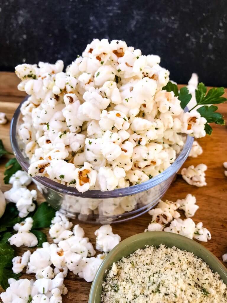 Ready in 10 minutes, Homemade Parmesan Garlic Popcorn is a fast and easy snack recipe. Parmesan cheese, garlic powder, and parsley season this healthy, gluten free, vegetarian appetizer. Great for party entertaining and game day. #homemadepopcorn #gamedayrecipes