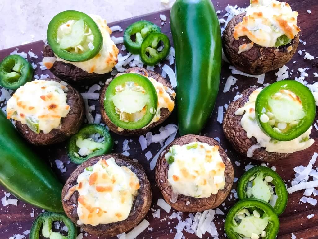 Jalapeno Popper Stuffed Mushrooms are a perfect game day appetizer.  A cream cheese mixture is combined with chopped jalapeno peppers and stuffed in mushroom caps.  Gluten free, low carb keto, and vegetarian. #gameday #jalapenopoppers #stuffedmushrooms