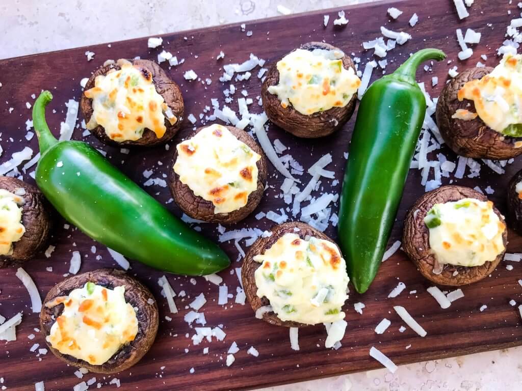 Jalapeno Popper Stuffed Mushrooms are a perfect game day appetizer.  A cream cheese mixture is combined with chopped jalapeno peppers and stuffed in mushroom caps.  Gluten free, low carb keto, and vegetarian. #gameday #jalapenopoppers #stuffedmushrooms