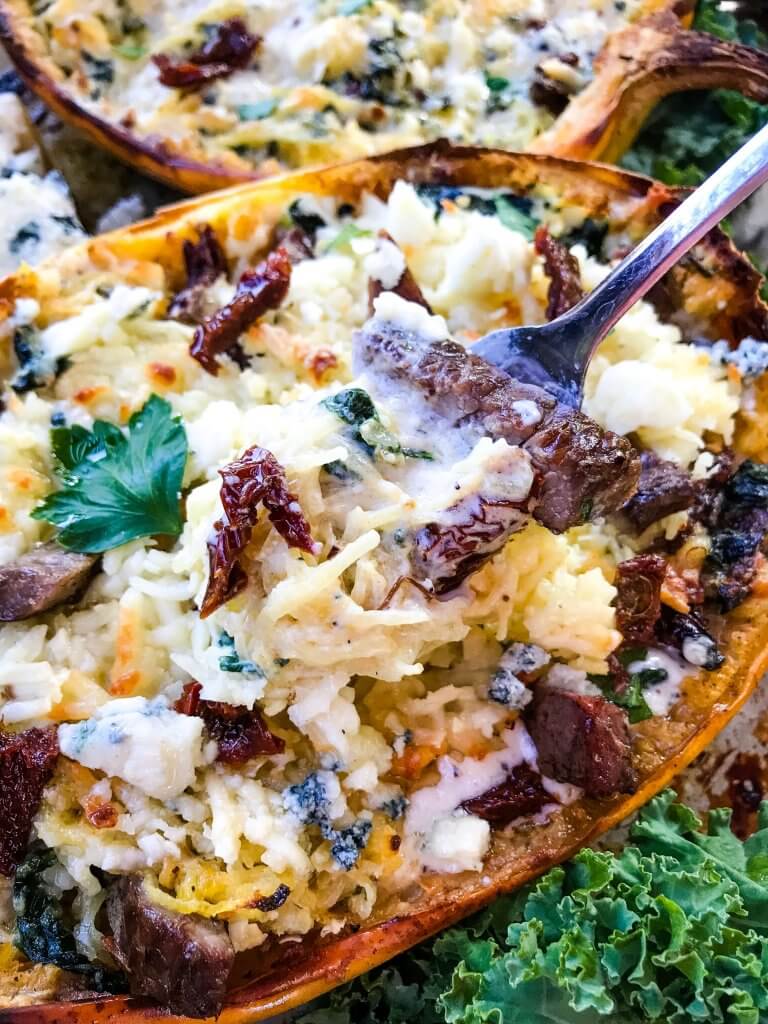 A stuffed spaghetti squash recipe, Keto Low Carb Steak Gorgonzola Alfredo Spaghetti Squash is a healthier low carb keto twist on a copycat Olive Garden pasta classic. Parmesan alfredo sauce mixed with sundried tomatoes, gorgonzola blue cheese, and spinach with steak. #copycatolivegarden #ketopasta #lowcarbpasta 