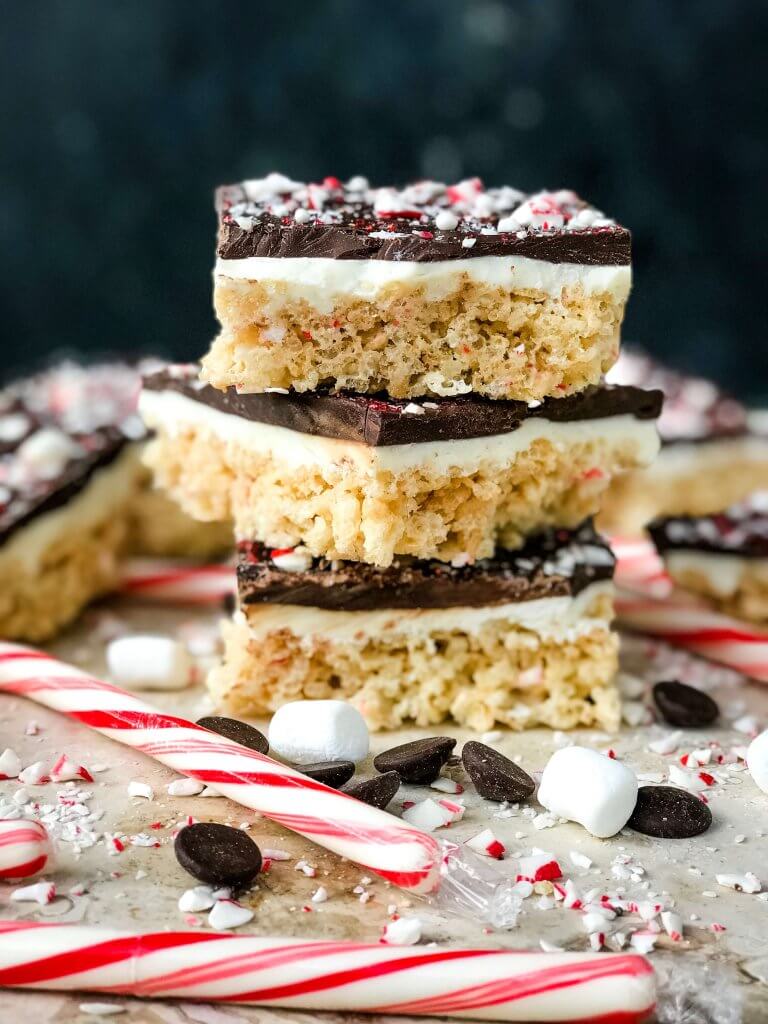 Three Peppermint Bark Rice Krispie Treats squares stacked on top of each other from the side