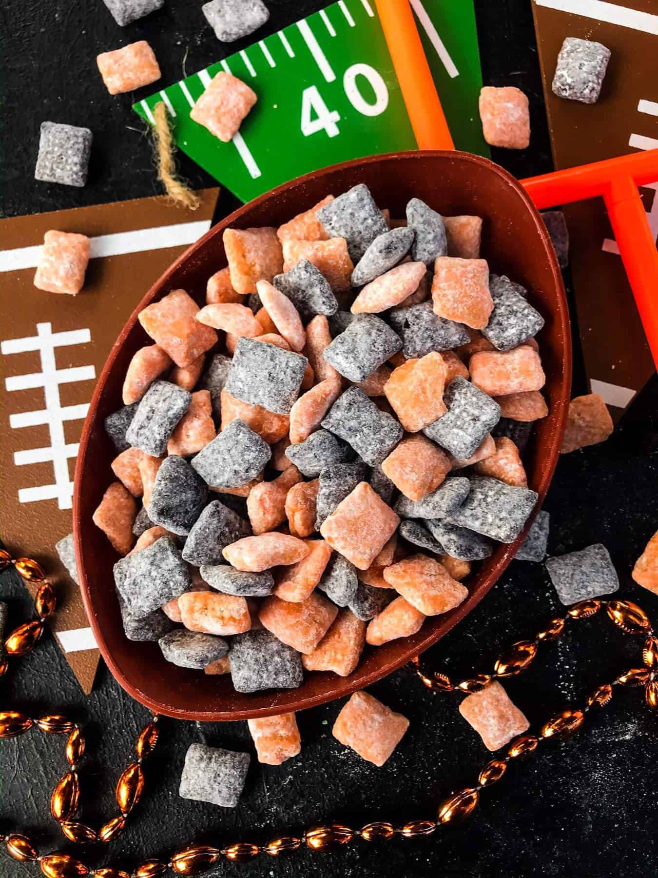 Top view of Cincinnati Bengals Puppy Chow in a football bowl on a football decorated table