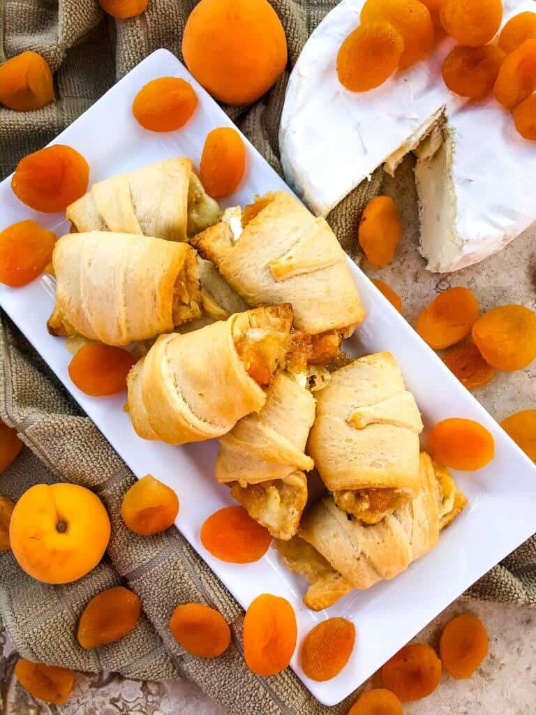 Apricot Brie Crescent Rolls are a cheese crescent roll recipe filled with apricot jam, dried apricots, and brie cheese. Fast and easy sweet bread recipe. #crescentrolls #cheesycrescentrolls #driedapricots