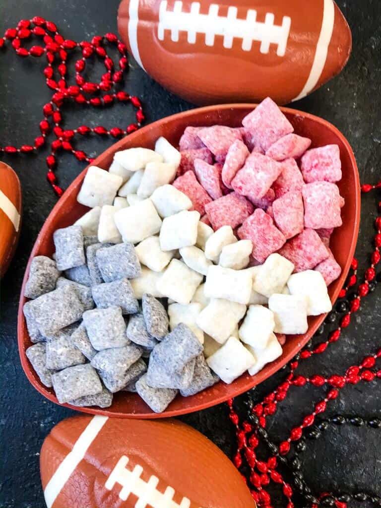 Atlanta Falcons Puppy Chow in a bowl surrounded by footballs