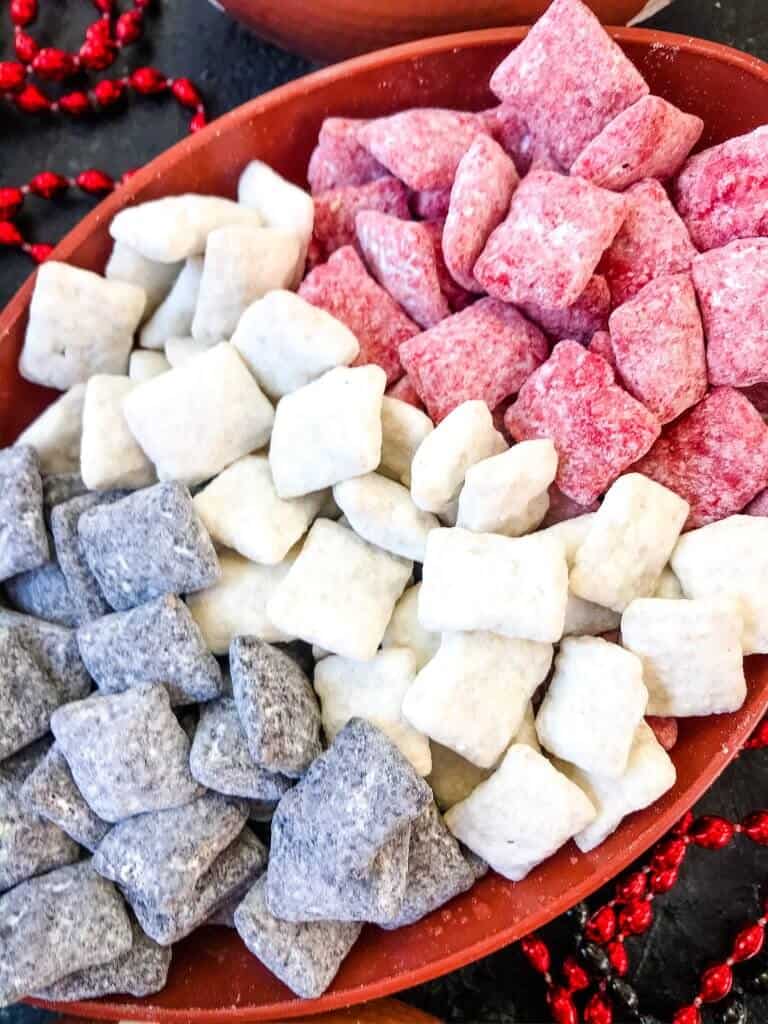 Black, white, and red Atlanta Falcons Puppy Chow separated in a football bowl