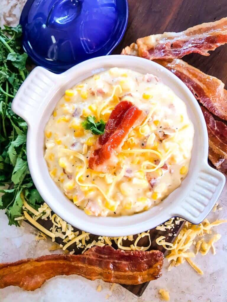 Cheddar Bacon Creamed Corn is a simple homemade creamed corn recipe perfect for a BBQ or Southern soul food meal. Corn is cooked with bacon, cheddar cheese, milk, and butter for a simple side dish. #creamedcorn #southernfood