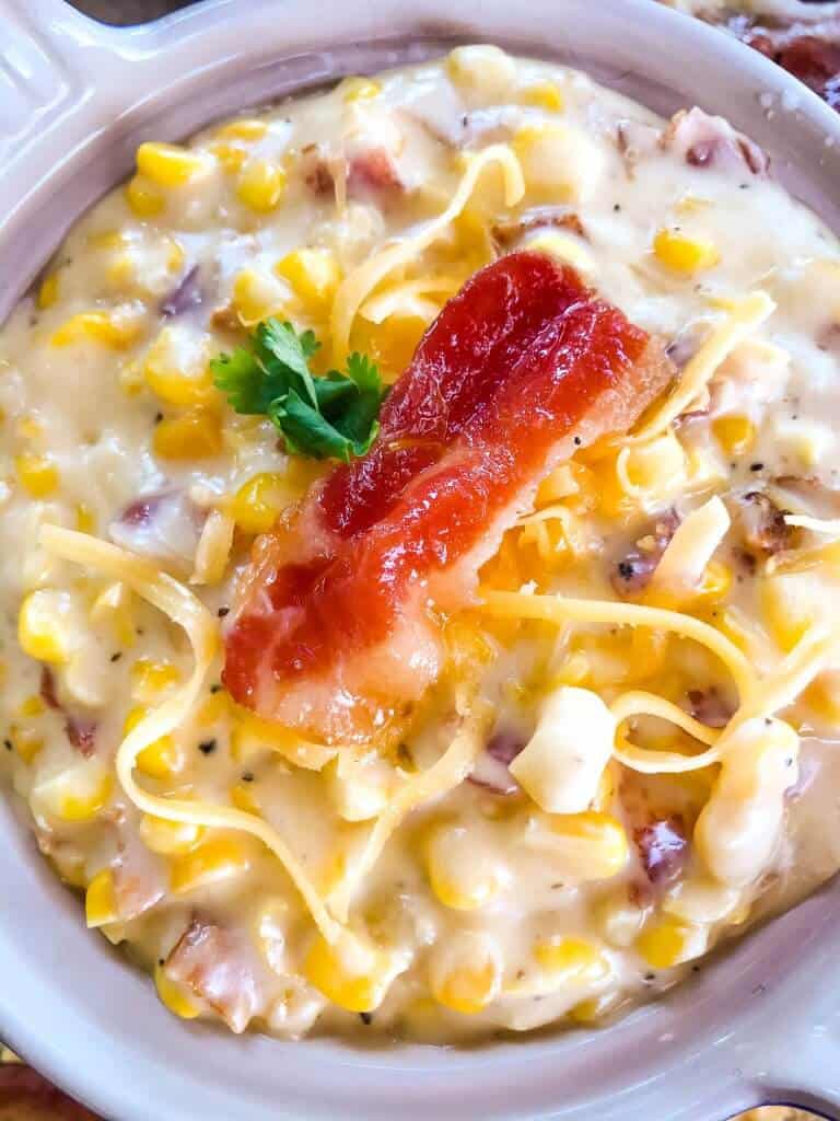 Cheddar Bacon Creamed Corn is a simple homemade creamed corn recipe perfect for a BBQ or Southern soul food meal. Corn is cooked with bacon, cheddar cheese, milk, and butter for a simple side dish. #creamedcorn #southernfood